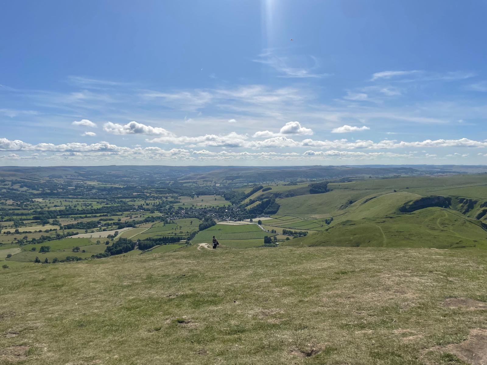 Green hills and patchwork fields in the Peak District on a sunny day